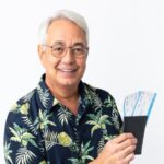 Senhor grisalho com passaporte e passagens aéreas